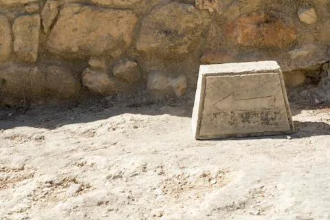 The arrow on the stone as a pointer. Stock Photos