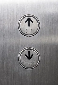 Arrow symbol with the braille on the push button. Stock Photos