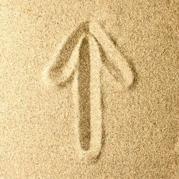 Arrow Written in the Sand Stock Photos