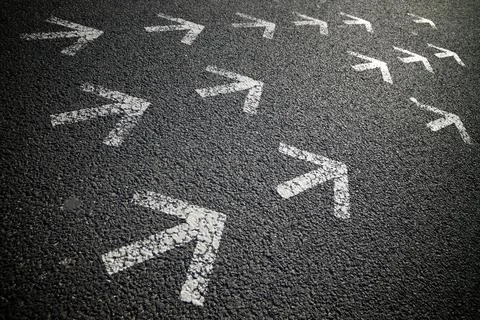 Arrows on asphalt Stock Photos