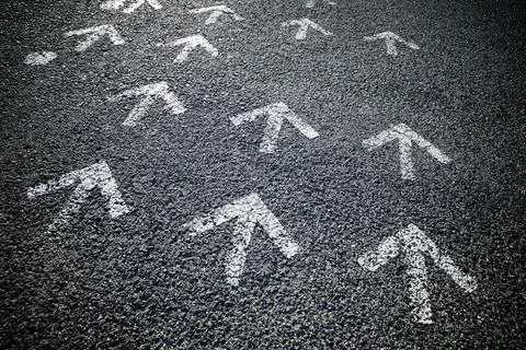 Arrows on asphalt Stock Photos