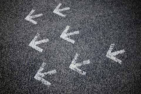 Arrows on asphalt Stock Photos