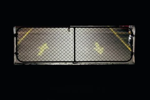 Arrows pointing up and down through a fence Stock Photos