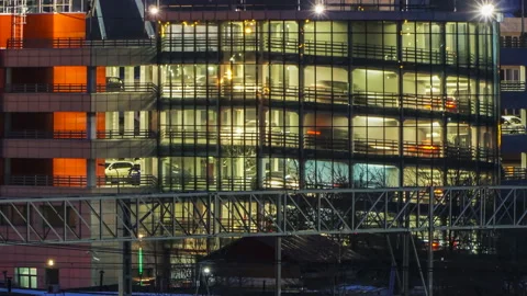 ?ars leave the multistory Parking of office building  at the end of the worki Stock Footage 104806684