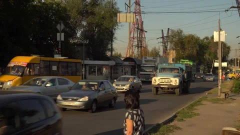 Ars stand at an intersection on a red light signal on one of the streets Stock Footage 139083384