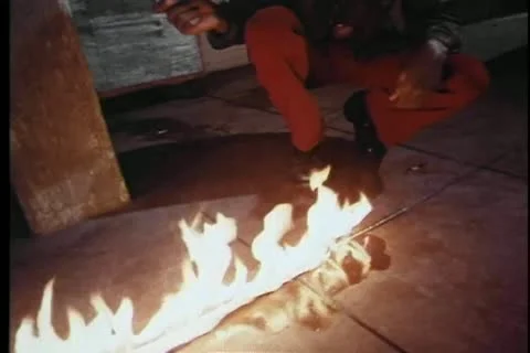 Arsonist setting fire to garbage cans Stock Footage 11357207