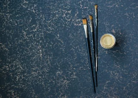 Art brushes on a dark background Stock Photos