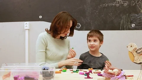 Art class modelling color doh, little boy and the teacher in the classroom Stock-Footage 102235670