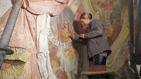 Art Conservator Restoring Historic Baroque Wall Painting Video stock 345258989