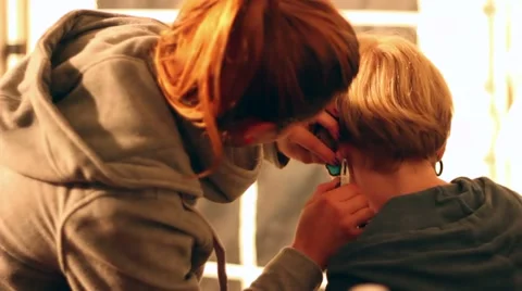 Art crafts and ear piercing at a festival Stock Footage 47322997