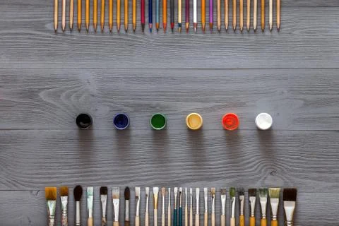 Art creative table background with supplies tools on grey wooden desk Stock Photos