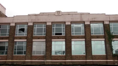 Art deco factory windows closed derelict urban decay Stock Footage 47452604