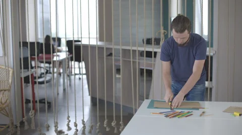 Art designer man with a beard, cuts paper stationery knife Stock Footage 67167666