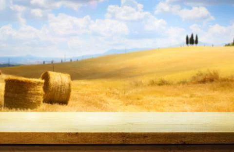 Art Empty wooden deck table on rural landscape background with italian golden Stock Photos
