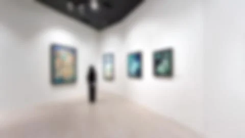 Art exhibition gallery blurry background and People looking at paintings on.. Stock Photos