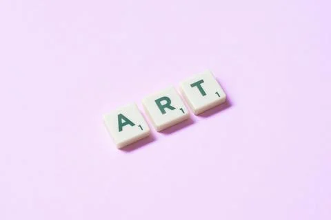 Art formed of scrabble elements on pink background. Foto stock