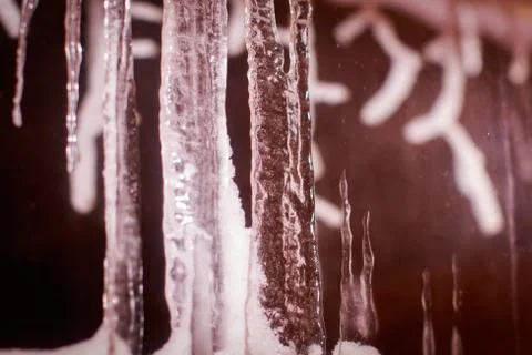 Art frame of white snow cold icicles on top foreground and stones beach Stock Photos