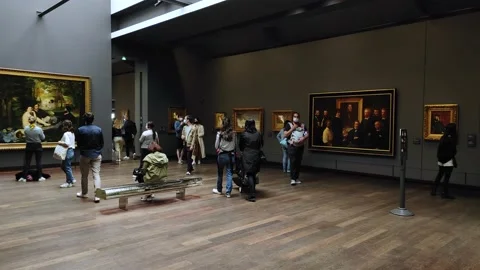Art gallery with multiple paintings and visitors inside the Orsay Museum Stock Footage 161943590