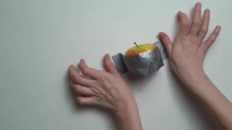 Art installation apple taped to a wall Stock Footage 146938207