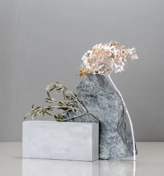 Art installation using concrete blocks, golden plants and natural stone. Stock Photos