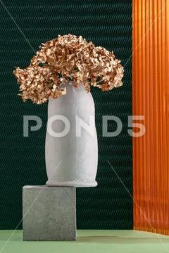 Art installation using elements of concrete, dried flowers and non-traditiona Stock Photos