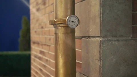 Art object, brick wall and rain pipes Stockbeeldmateriaal 74064079