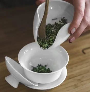 The Art of Preparing Herbal Tea Using Elegant White Ware Alongside Fresh Stock Photos