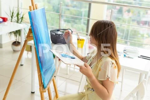 Art school, creativity and leisure concept - student girl or young woman artist Stock Photos