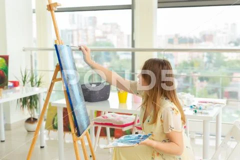 Art school, creativity and leisure concept - student girl or young woman artist Stock Photos
