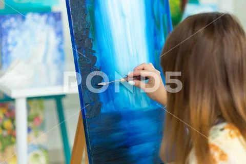 Art school, creativity and leisure concept - student girl or young woman artist Stock Photos