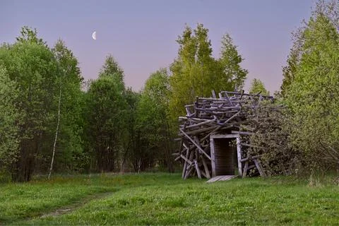 Art structure, a hut made of branches in a park at dawn in Yasno Pole Russia Stock Photos
