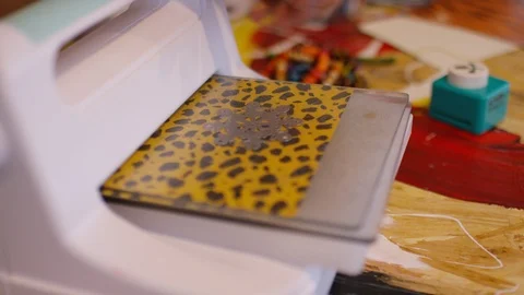Art student cutting out a complex star shape on paper using a roller device Stock Footage 112024561