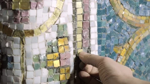 Art studio craftsperson inserts golden glass square mosaic Stock Footage 146254762