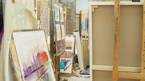 Art studio in university with painter workin on easel. Shot on RED Stock Footage 105066579