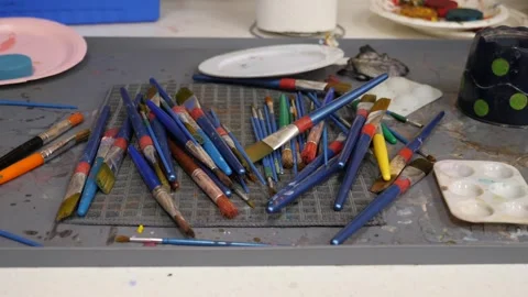 Art supplies clutter on a creative workspace Stock Footage 311944442