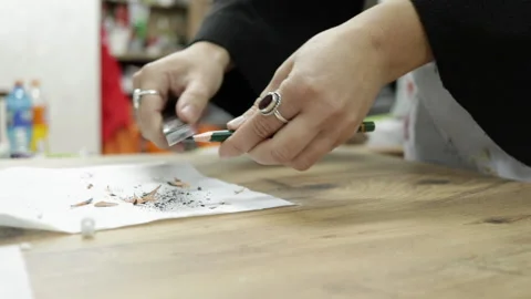 Art teacher sharpens her pencil Stock Footage 152853328
