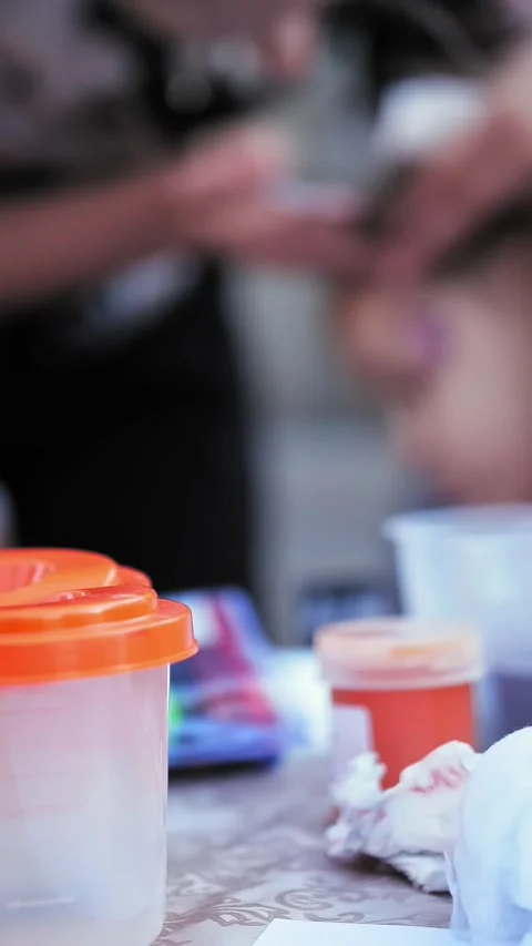 Art tools. face painting. close-up. paints, brushes, water cups. blurred Stock Footage 319899166