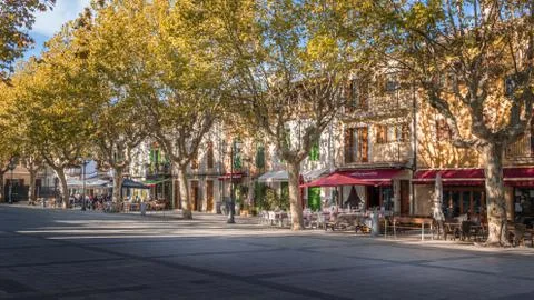 Arta town square (Placa). Centre of typical Spanish town in Autumn. Restauran Stock Photos