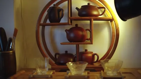 Artful display of handcrafted tea pots in a cozy setting Stock Footage 296012718
