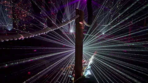Artful night laser light show in forest, rope fence in foreground Stock Footage 328626900
