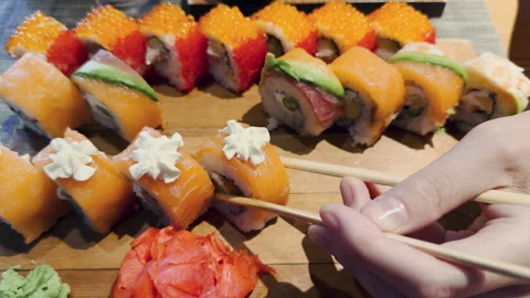 Artfully crafted sushi rolls on an elegant wooden platter Stock Footage 280833439