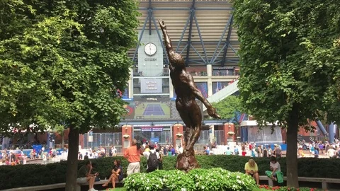 Arthur Ashe Statue stands in front of USTA at Flushing Meadows at famed tennis Stock Footage 71202190