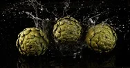 Artichoke, Cynara Scolymus, Vegetables Falling Into Water On Black Background, Stock Footage