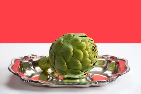 Artichoke on a platter Stock Photos