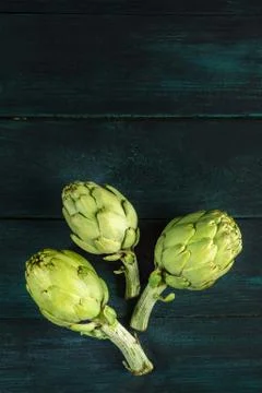 Artichokes on dark rustic texture with copyspace 写真素材