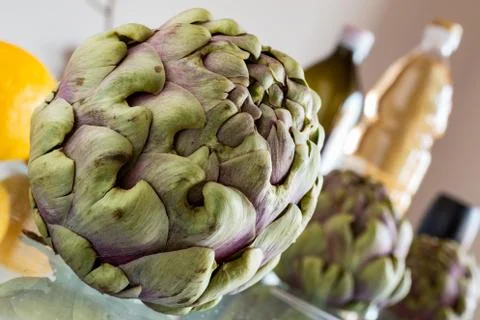 Artichokes in kitchen with oil Stock Photos