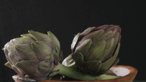 Artichokes spinning in black background Stock Footage 274648010