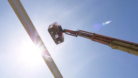 Articulated manlift working at construction site. Shot from below manlift. 스톡 동영상 129299727