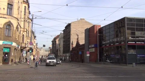Articulated tram exchanges passengers at a stop at Matisa Street Stock Footage 64638933
