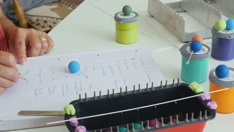 Artiest writes down her ideas for matching colours togeather Stock Footage 77111345